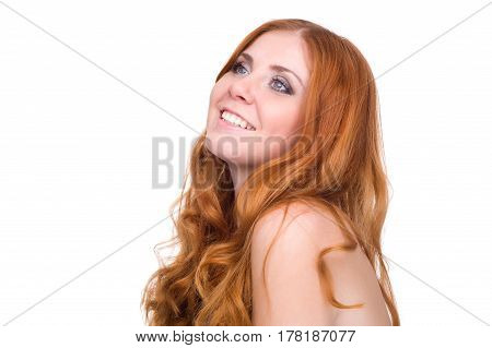 studio portrait of pretty redhead girl on a light background.