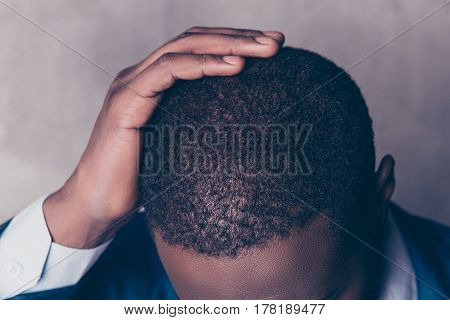 Close up cropped portrait of successful handsome afroamerican man in stylish suit touching his hair
