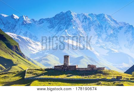 A fascinating view on Ushguli village at the foot of snow-capped Mt. Shkhara. Location place Lamaria Church Jgrag Upper Svaneti Georgia Europe. Happy lifestyle. Beautiful universe.