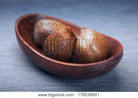 Salak fruit or snake fruit in a wooden textured plate exotic plants