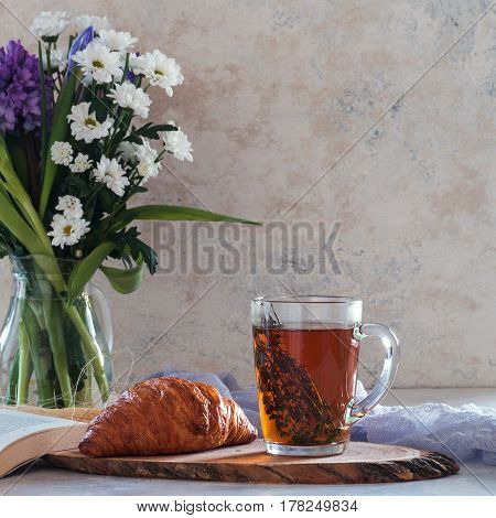 Cup Of Tea With Thyme And Bouquet Of Flowers On Background. Spring Concept