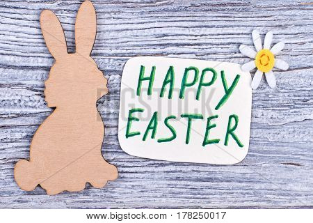 Wooden Easter rabbit. Easter holiday card. Wishing for happy Easter.
