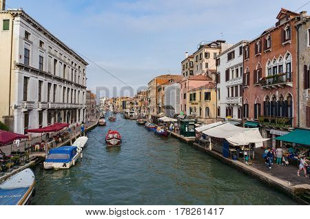 View On Cannaregio Canal With Boats And Fruit Market