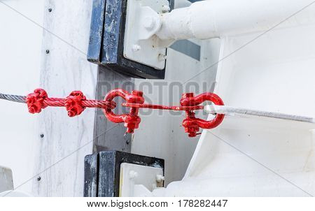 Red Cable and Turnbuckles on White bulkhead