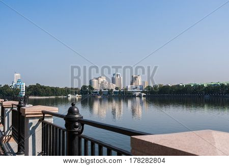Yekaterinburg, Russia - August,04,2016: View to city center Yekaterinburg and Iset river in summer morning. Seen Dynamo Sports complex the concert center Space and modern houses. View from opposite bank of river.