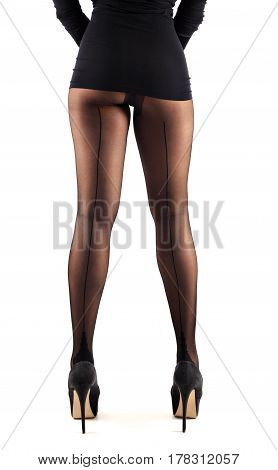 Sexy female legs in beautiful stylish stockings and high heels shoes black gloves and dress isolated on white background