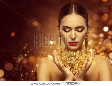Fashion Model Holding Gold Jewelry in Hands Woman Golden Beauty Beautiful Girl Makeup and Luxury Jewellery