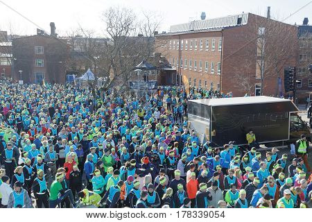 STOCKHOLM SWEDEN - MAR 25 2017: Crowd of runners men and woman in blue vests and yellow bandeau waiting for the start in the Stockholm Tunnel Run Citybanan 2017. March 25 2017 in Stockholm Sweden