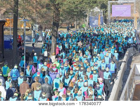STOCKHOLM SWEDEN - MAR 25 2017: Crowd of runners men and woman in blue vests and yellow bandeau waiting for the start in the Stockholm Tunnel Run Citybanan 2017. March 25 2017 in Stockholm Sweden