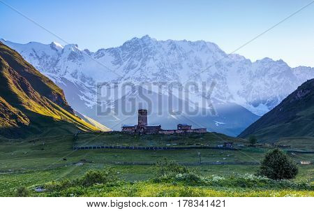 A fascinating view on Ushguli village at the foot of snow-capped Mt. Shkhara. Location place Lamaria Church Jgrag Upper Svaneti Georgia Europe. Happy lifestyle. Beautiful universe.