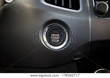 Engine start stop button. Car dashboard.  Auto inside.