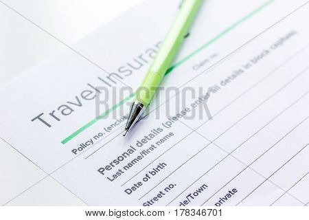 Traveling concept with insurance application form on white table background