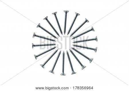 closeup of metal screws arranged in circle on white background
