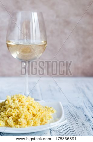 Portion Of Risotto With Glass Of White Wine