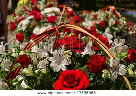 Basket with red rose and lily flowers Saint George ribbon
