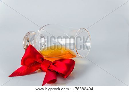 Single Malt Whiskey Glass With Red Bow On A White Background