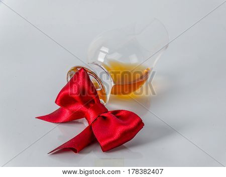 Single Malt Whiskey Glass With Red Bow On A White Background