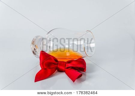 Single Malt Whiskey Glass With Red Bow On A White Background
