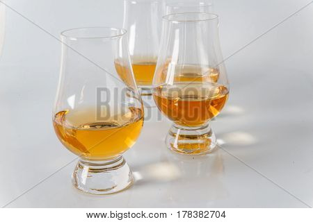 Delicious Single Malt Whiskey Glass With Another Glasses On A White Background