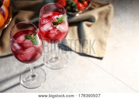 Glasses of delicious wine spritzer on table