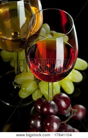 Červené a bílé víno v brýlích s hroznovým vínem. Pohled shora