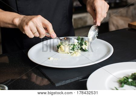 Crop shot of chef cook preparing mashed potatoes on plate.