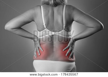 Back pain kidney inflammation ache in woman's body black and white photo with red spots