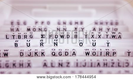Burn out letters in focus between other blurred lettters.