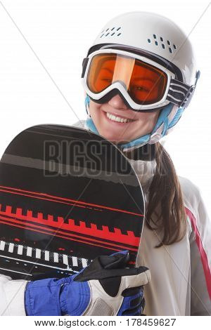 Young girl snowboarder in the helmet and glasses holds its Board and smiling.
