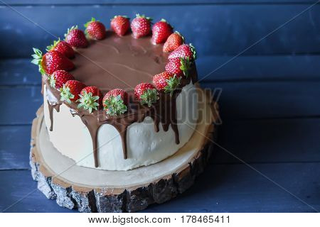 Delicious cake with fresh strawberry and dark chocolate sauce