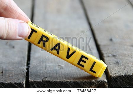 Travel concept. Word on a wooden old table