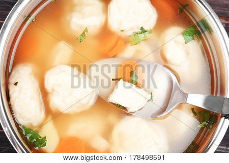 Stewpan with delicious chicken and dumplings closeup