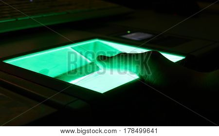 green cybersecurity digital fingerprint scanning on a green screen