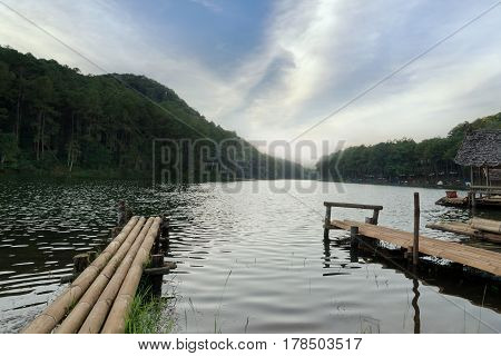 Bamboo bridge beside the lake in the mist at morning sunrise at Pang Ung (Pang Tong reservoir) Mae Hong Son province Thailand