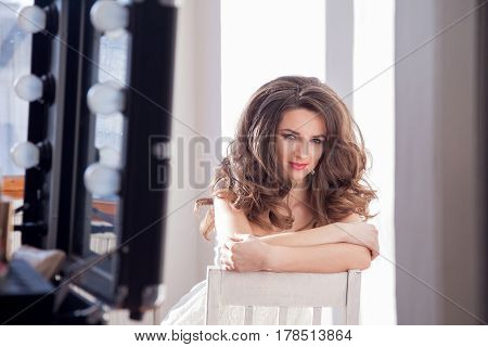 the girl did makeup and hairstyle curls