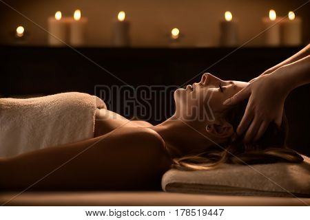 The beautiful young girl getting a spa treatment. Facial massage