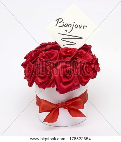 A bouquet of red roses made from satin ribbon with an inscription