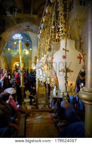 JERUSALEM ISRAEL - MARCH 25 2017: Lampades over the stone of Chrismation in the Church of the Holy Sepulcher