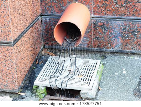 Gutter Deicing Solutions. Roof & Gutter Heating. Close up on gutter downspout drainage pipeline deicing cable installation. Heat Cables.