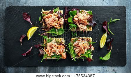 Smoked salmon flakes on salad bed and irish potato slims snacks, appetizers.