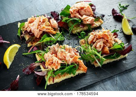 Smoked salmon flakes on salad bed and irish potato slims snacks, appetizers.