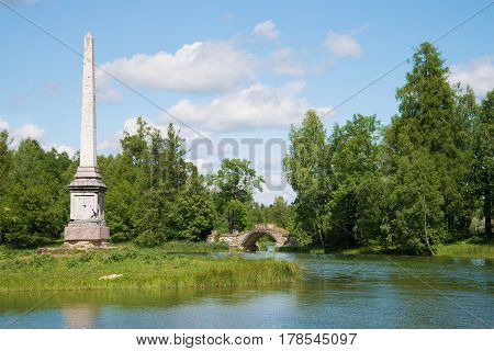 A view of the Chesme obelisk and the Humped bridge on the Gatchina palace park. Leningrad region, Russia