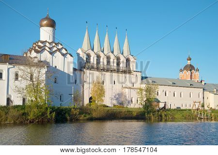 View of a belltower of the Tikhvin Uspensky monastery in the October evening. Tikhvin, Russia