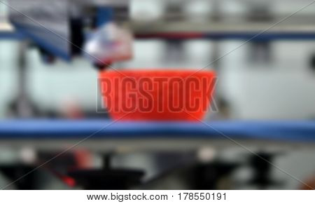 Work 3d printer close. Printing 3D printer Object Orange plastic On blue background. Plastic Wire Filament, Modern printing technology. Progressive additive technology