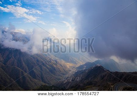 The Sun behind the clouds over mountains