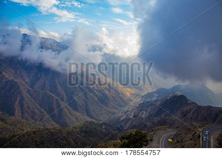 The Sun behind the clouds over mountains