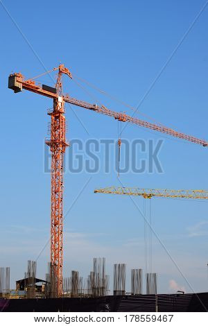 large cranes at the site of construction of buildings
