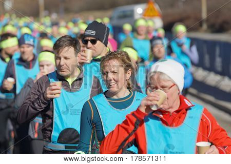 STOCKHOLM SWEDEN - MAR 25 2017: Group of runners drinking water in the Stockholm Tunnel Run Citybanan 2017. March 25 2017 in Stockholm Sweden