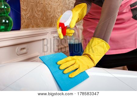 Female hands in gloves cleans sanitary equipment