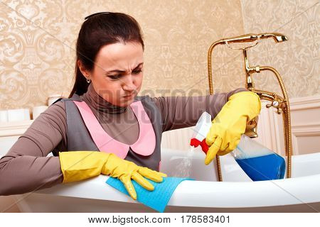 Woman from cleaning servisce sitting in bath